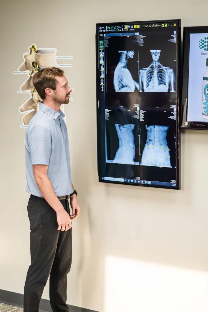Dr. Britton Goldsmith looking at chiropractic patient x-rays