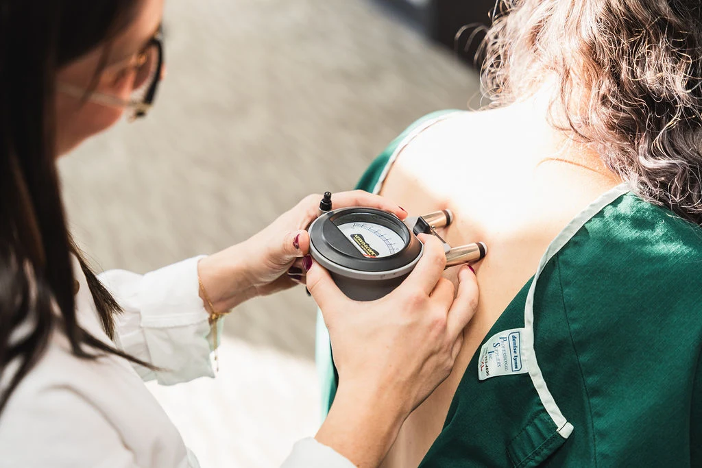 Gonstead equipment checking spinal misalignments preparing for adjustment