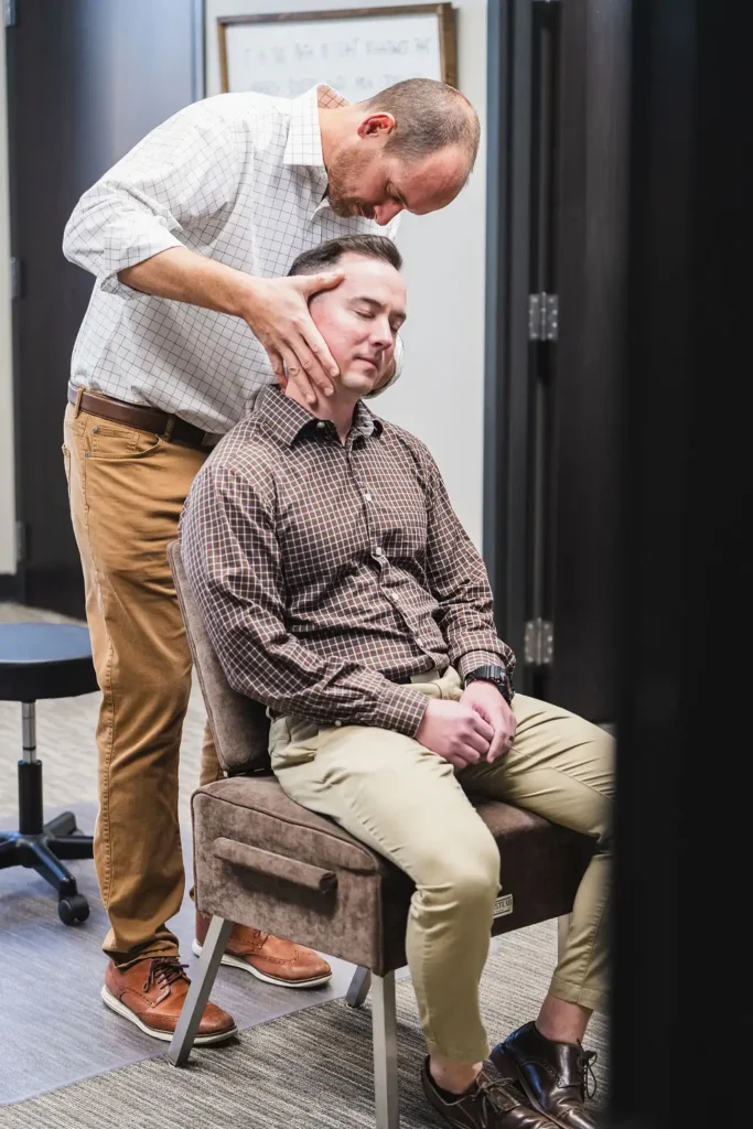 Dr. Blake Wayson executes neck chiropractic adjustment on male patient