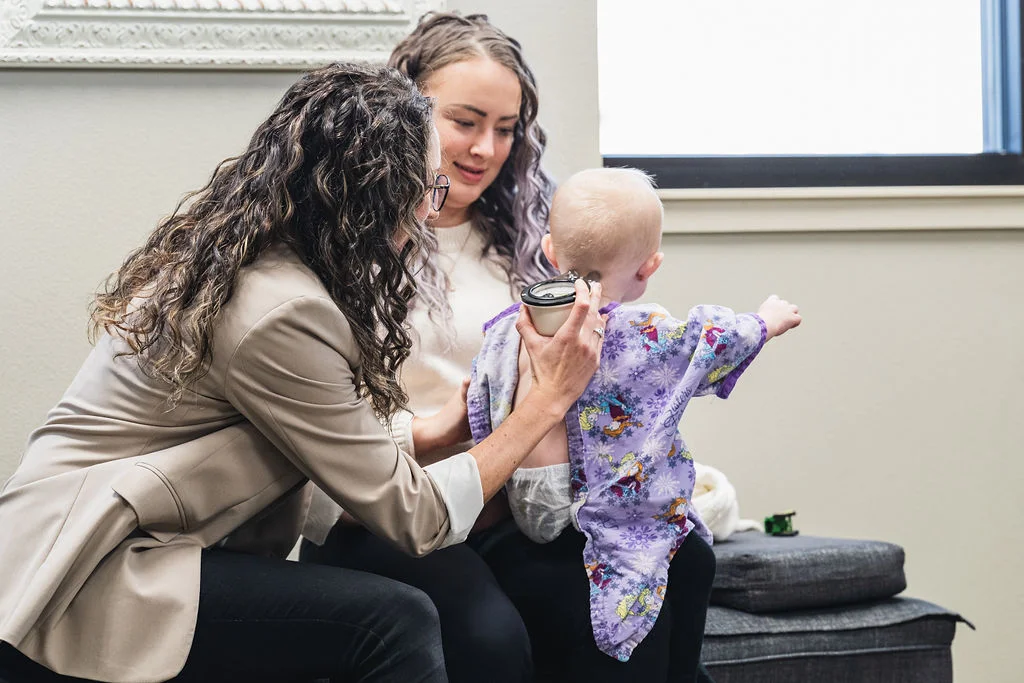 Dr. Sara Cahill is checking the upper neck spinal health using nervo-scope precision series for Gonstead technique