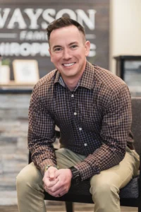 Dr. Thad looking professional sitting on a chair at Wayson Family Chiropractic