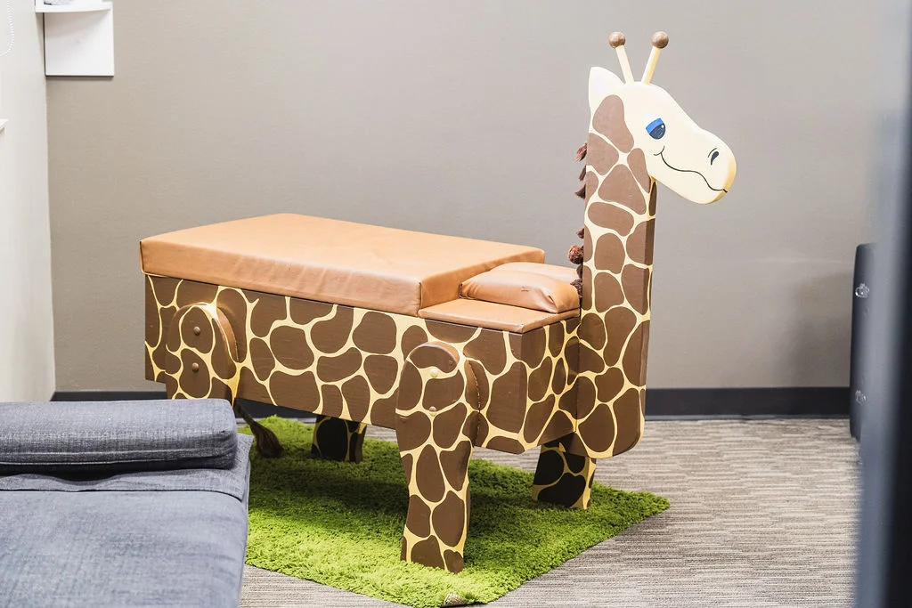 Cute kid-friendly giraffe styled adjustment table at Wayson Family Chiropractic