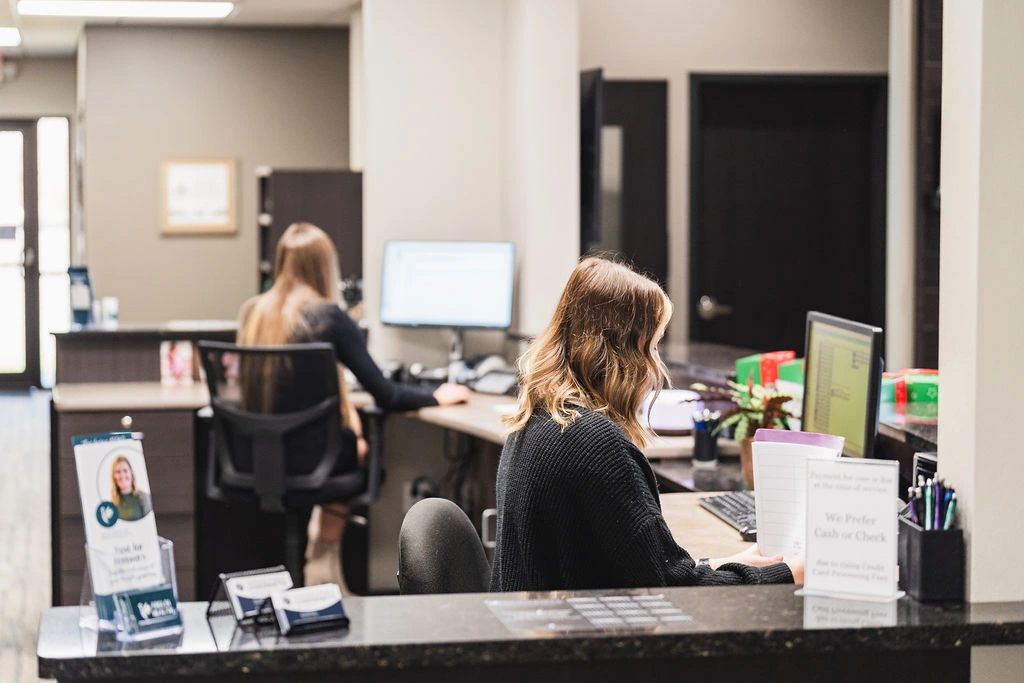 Wayson Family Chiropractic staff scheduling new patients at computers