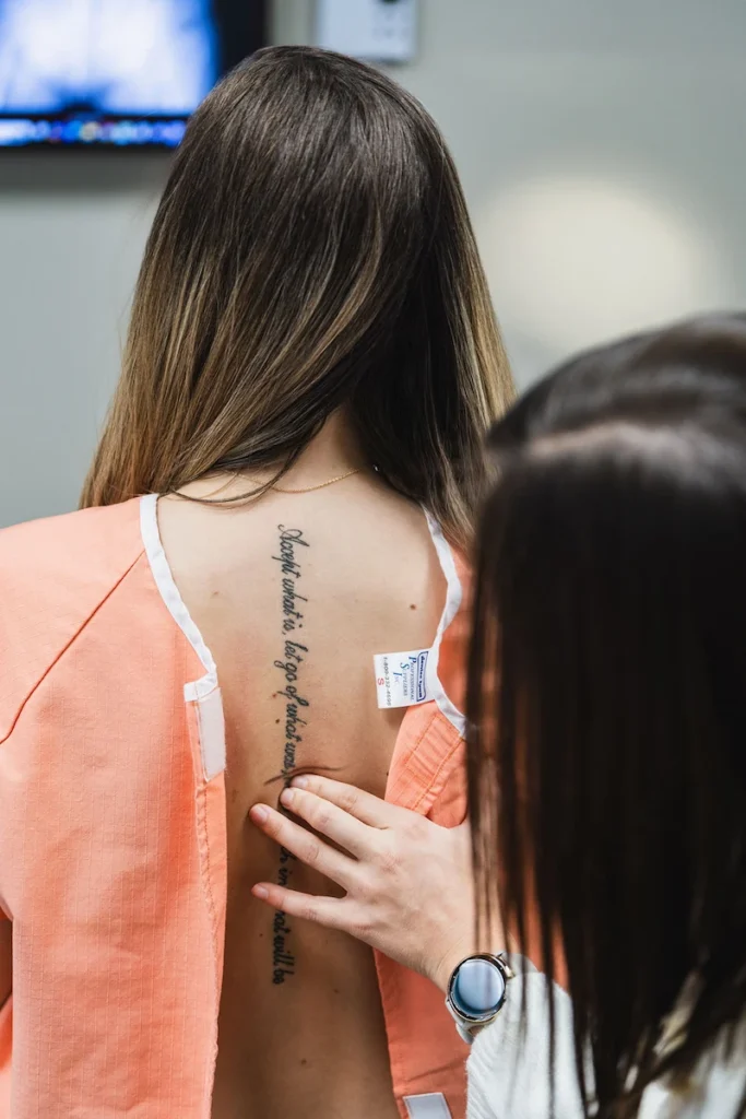 Chiropractic patient having her back examined by female chiropractor