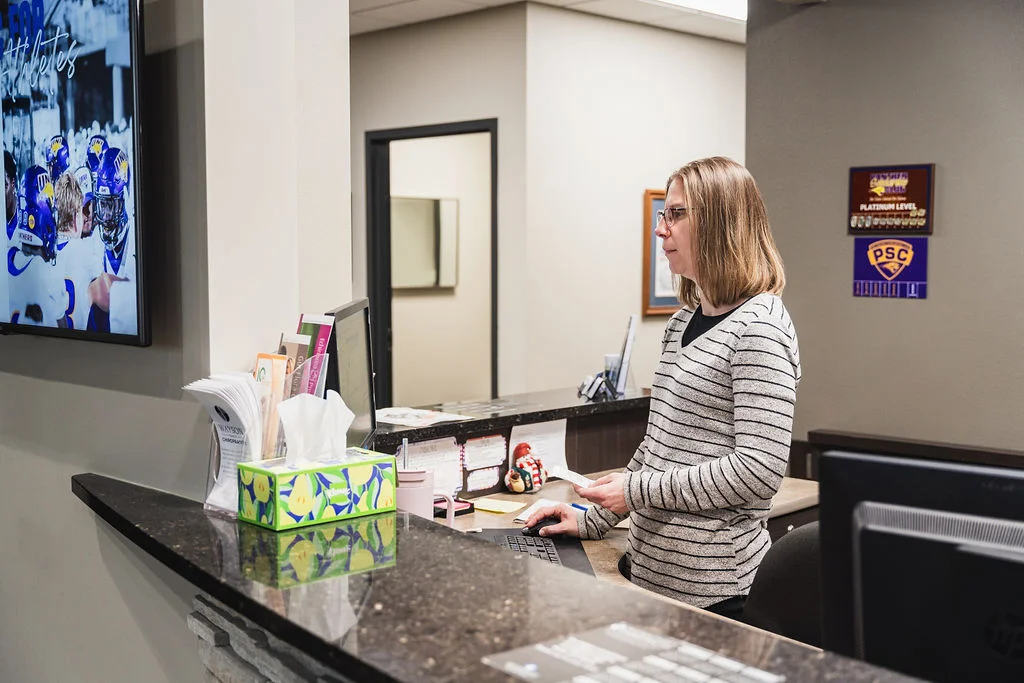 Wayson Family Chiropractic staff smiling reviewing patient scheduling