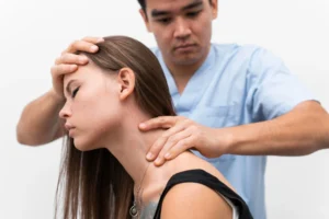 Chiropractor treating woman for whiplash injury recovery after car accident
