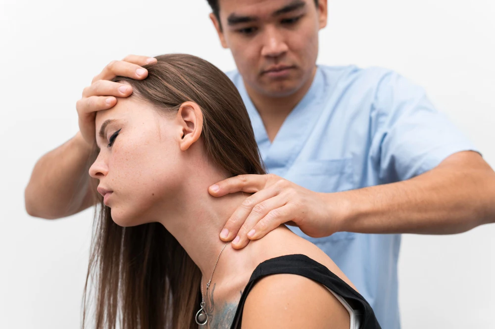 Chiropractor treating woman for whiplash injury recovery after car accident
