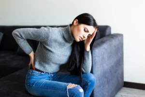Woman experiencing herniated disc pain in lower back