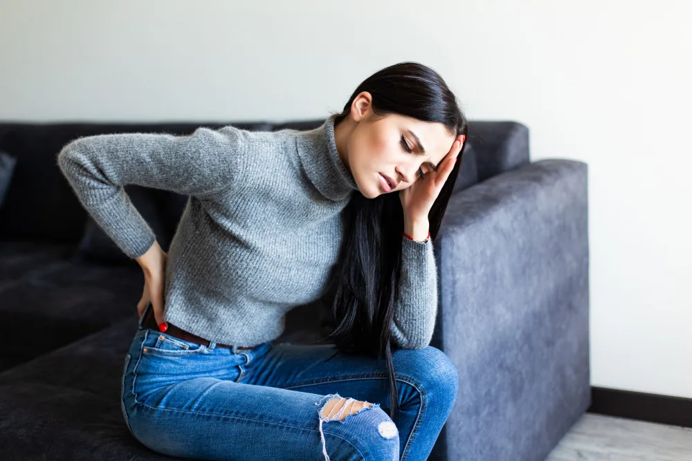 Woman experiencing herniated disc pain in lower back