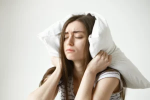 Woman struggling to sleep due to back pain and discomfort