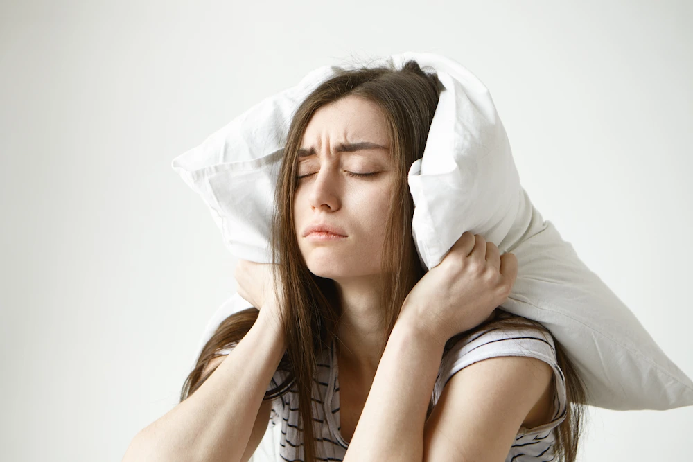 Woman struggling to sleep due to back pain and discomfort
