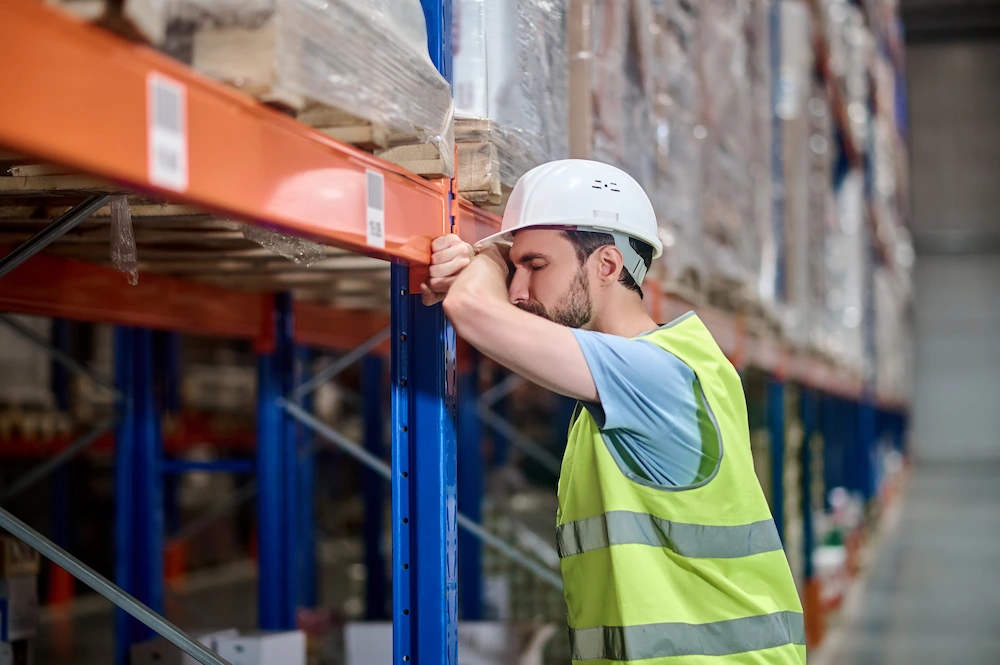 Chiropractor treating warehouse worker for repetitive strain injury with targeted therapy and adjustment