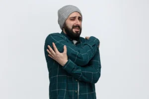 Man holding shoulder due to joint pain in cold weather